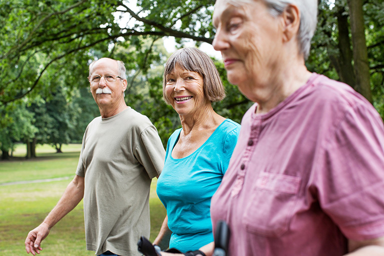 Healthy senior people walking in park