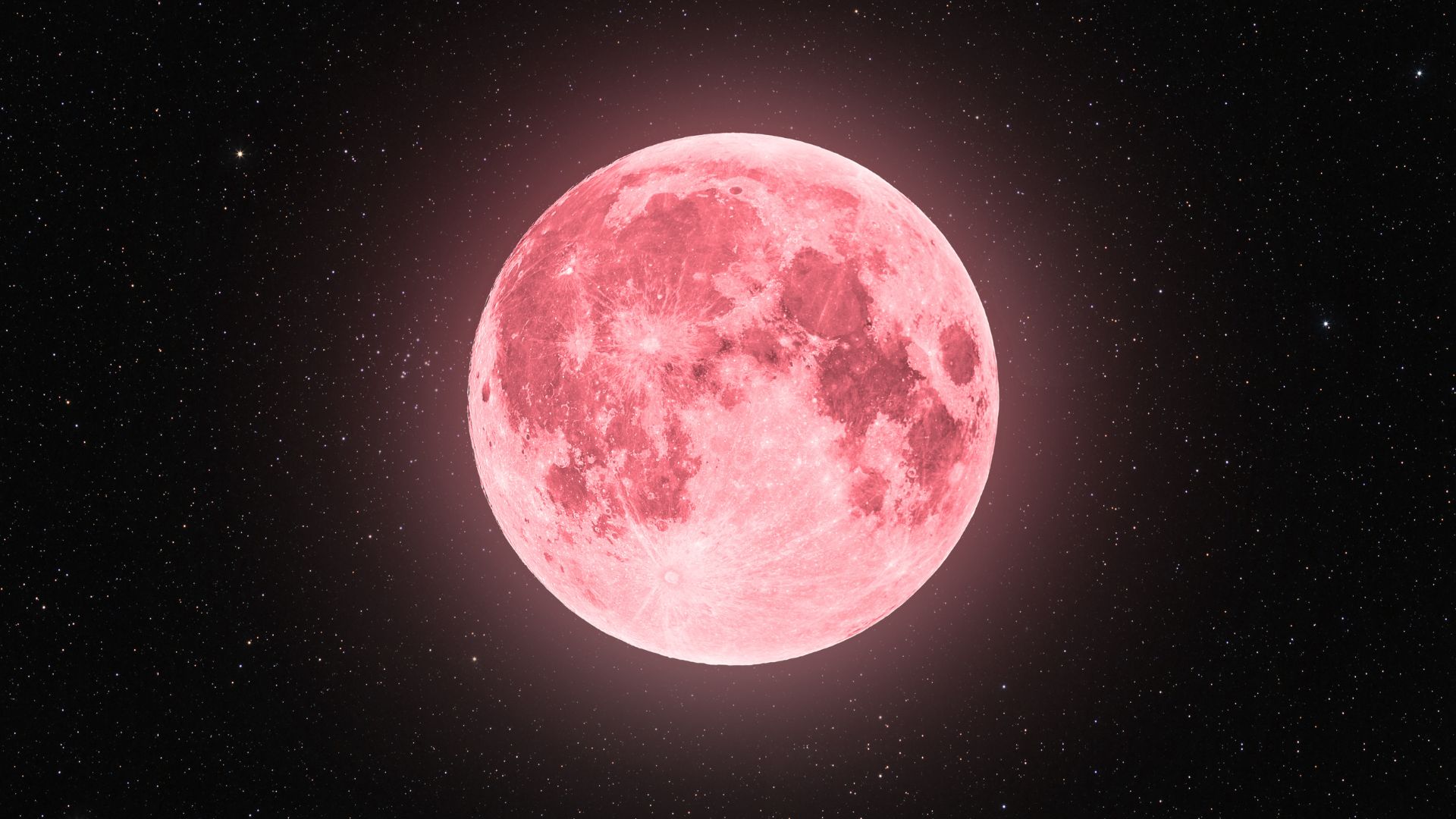 Luna llena de tonalidad rosada brillando en el cielo nocturno estrellado.