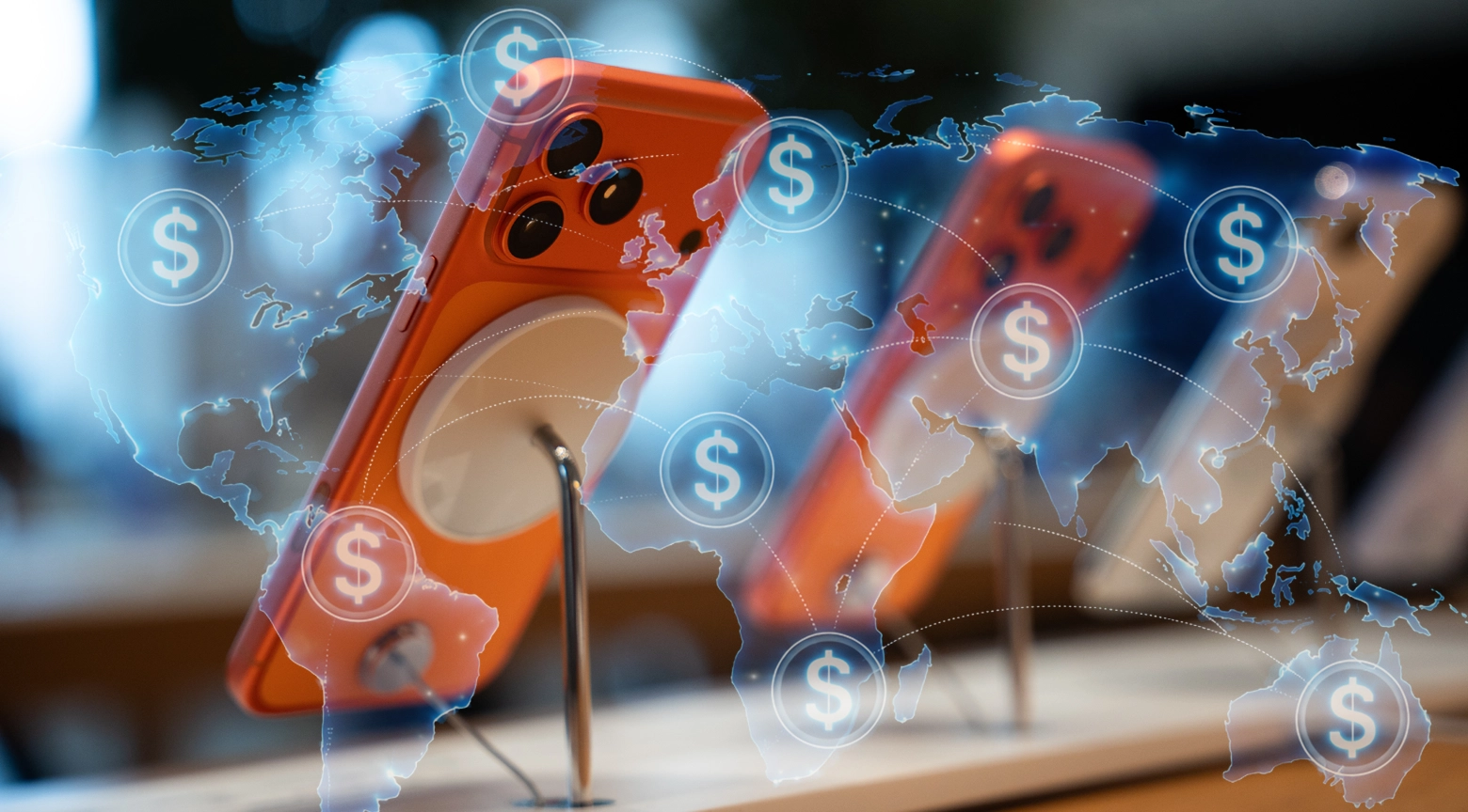 Teléfonos iPhone exhibidos en bases sobre un mostrador, superpuestos con un mapa mundial digital con símbolos de dólar interconectados.