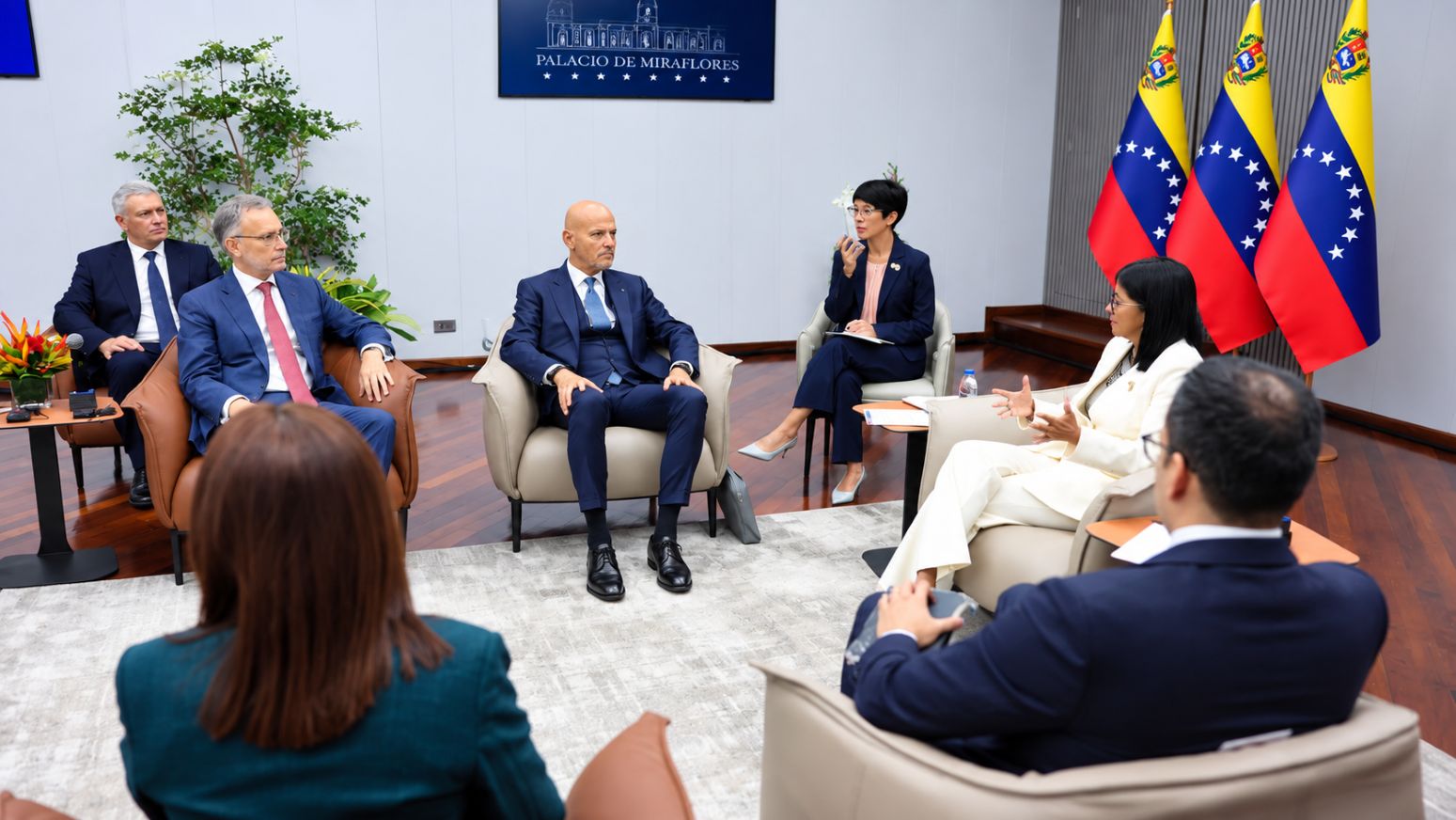 Representantes del Gobierno venezolano y del sector energético internacional reunidos en el Palacio de Miraflores, en Caracas, con banderas de Venezuela al fondo.